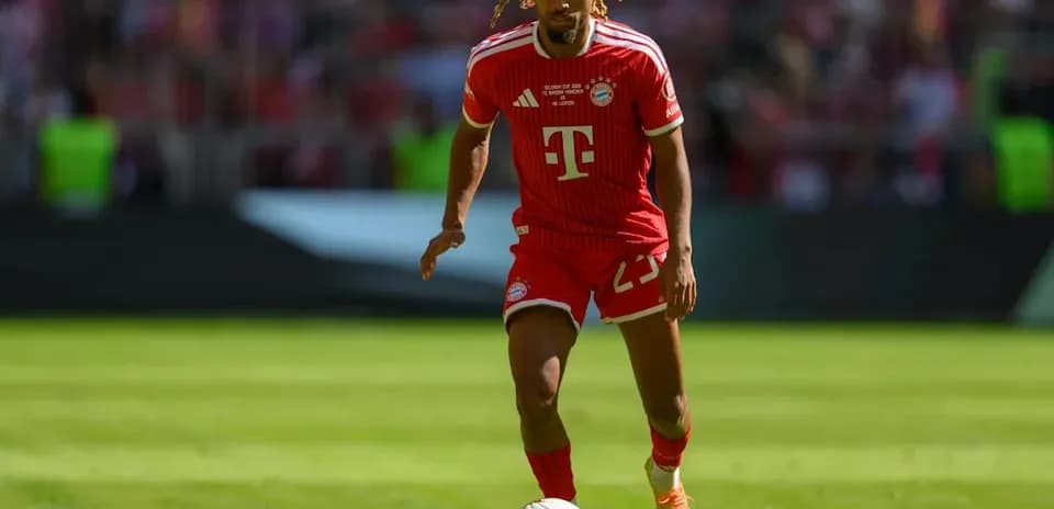 Bayern Munich player dribbling ball on field