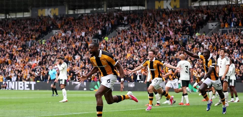 Hull City players celebrating a goal with fans