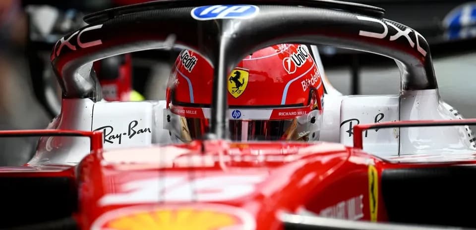 F1 driver in Ferrari car during race preparation