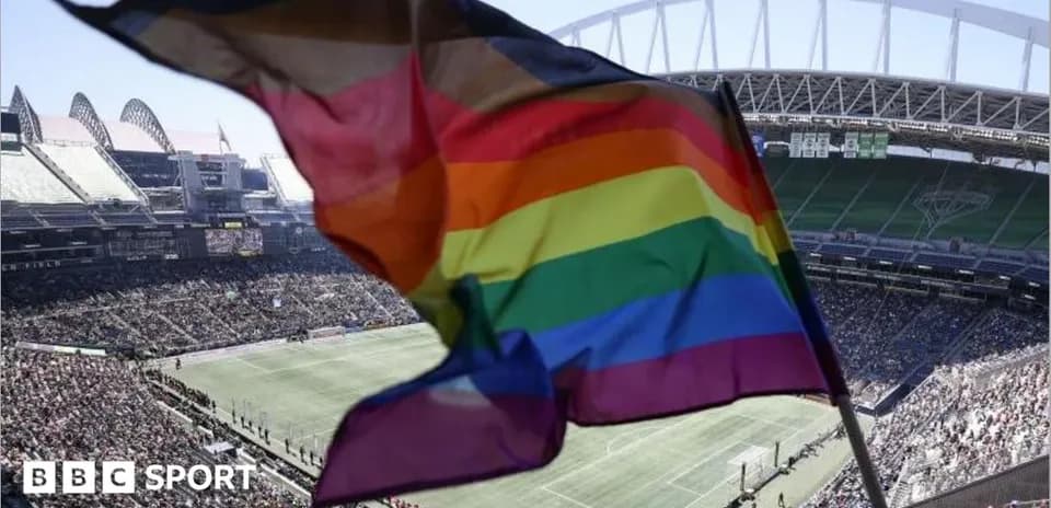 Rainbow flag waving in stadium during match