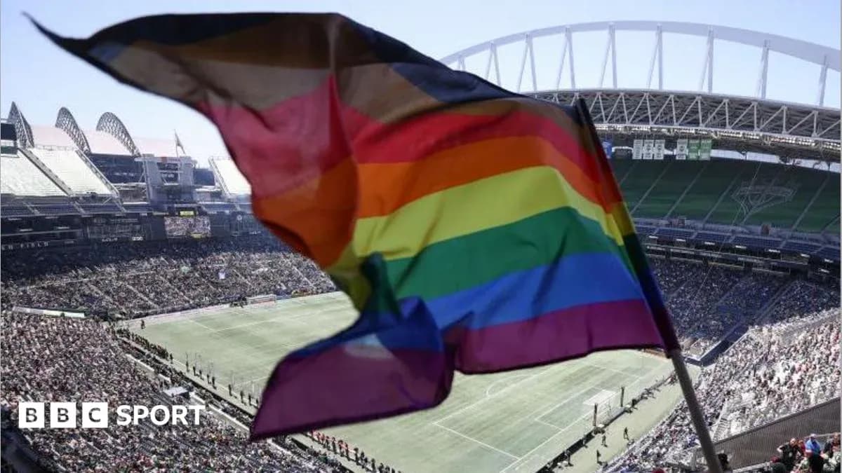 Rainbow flag waving in stadium during match
