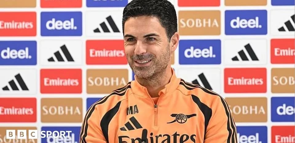 Mikel Arteta speaking at press conference with backdrop