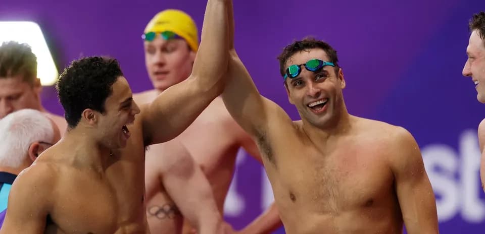 Two swimmers celebrating after a competition