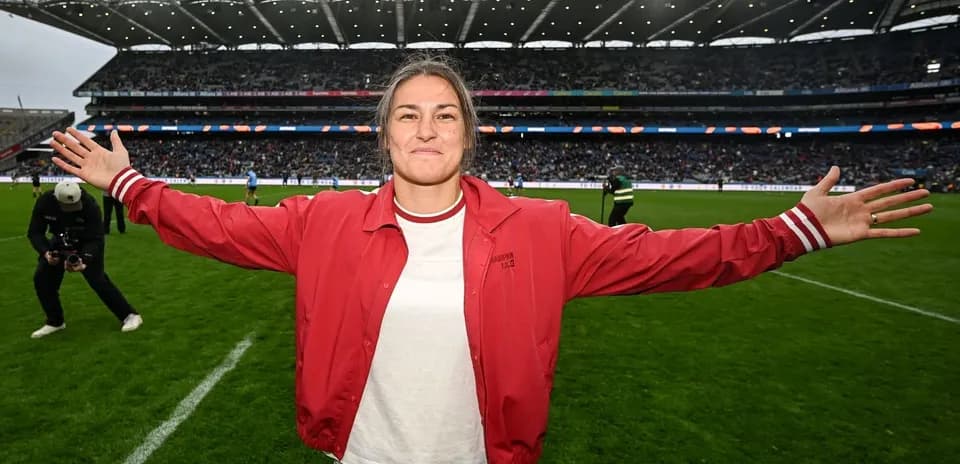 Athlete celebrating on the field with arms outstretched
