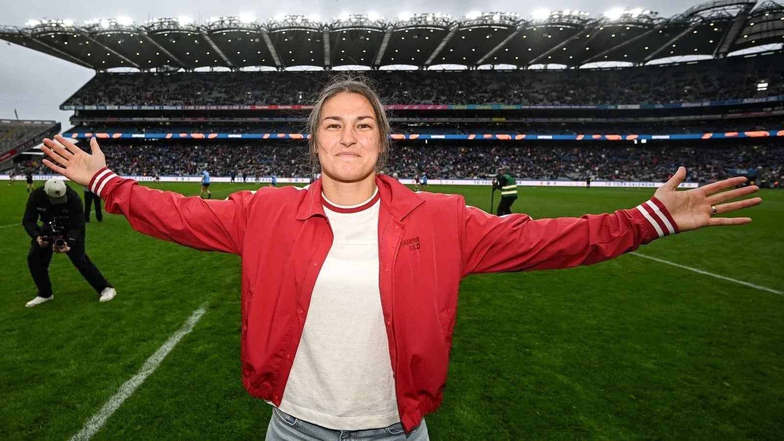 Athlete celebrating on the field with arms outstretched