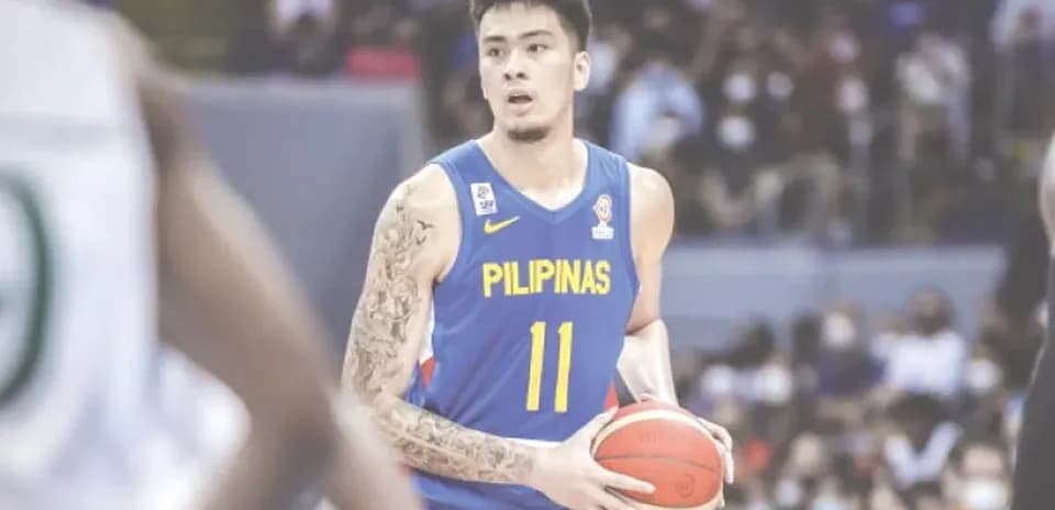 Basketball player in blue jersey holding ball