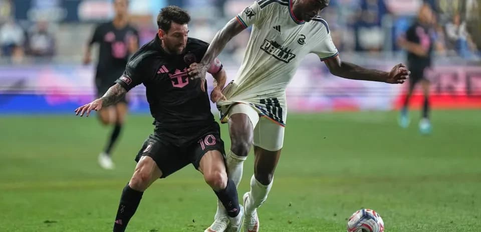 Two players battling for the ball on field
