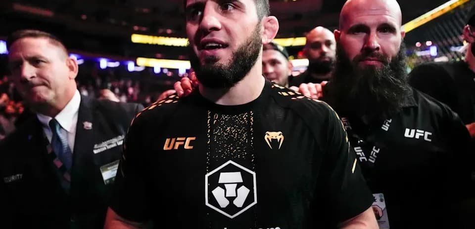MMA fighter entering the arena surrounded by team