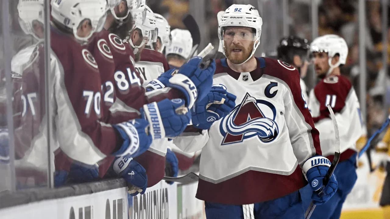 Hockey player celebrating with teammates on bench