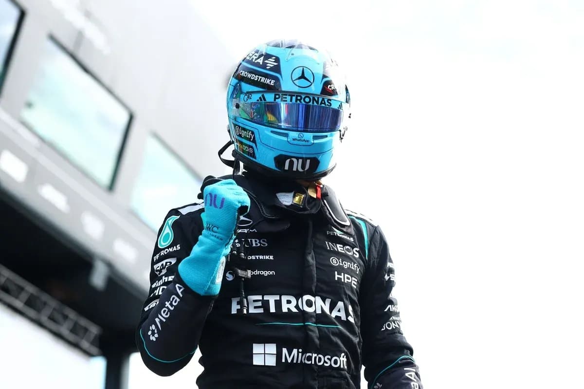 Formula 1 driver celebrating in racing suit Formula 1 driver celebrating in racing suit