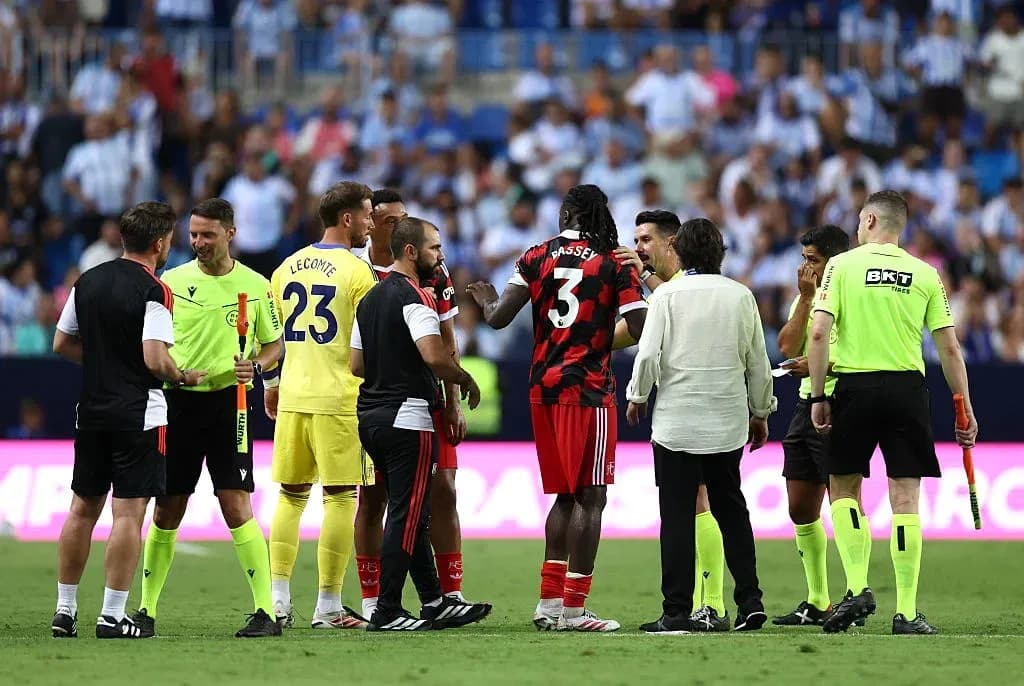 Players and officials discussing on the field Players and officials discussing on the field