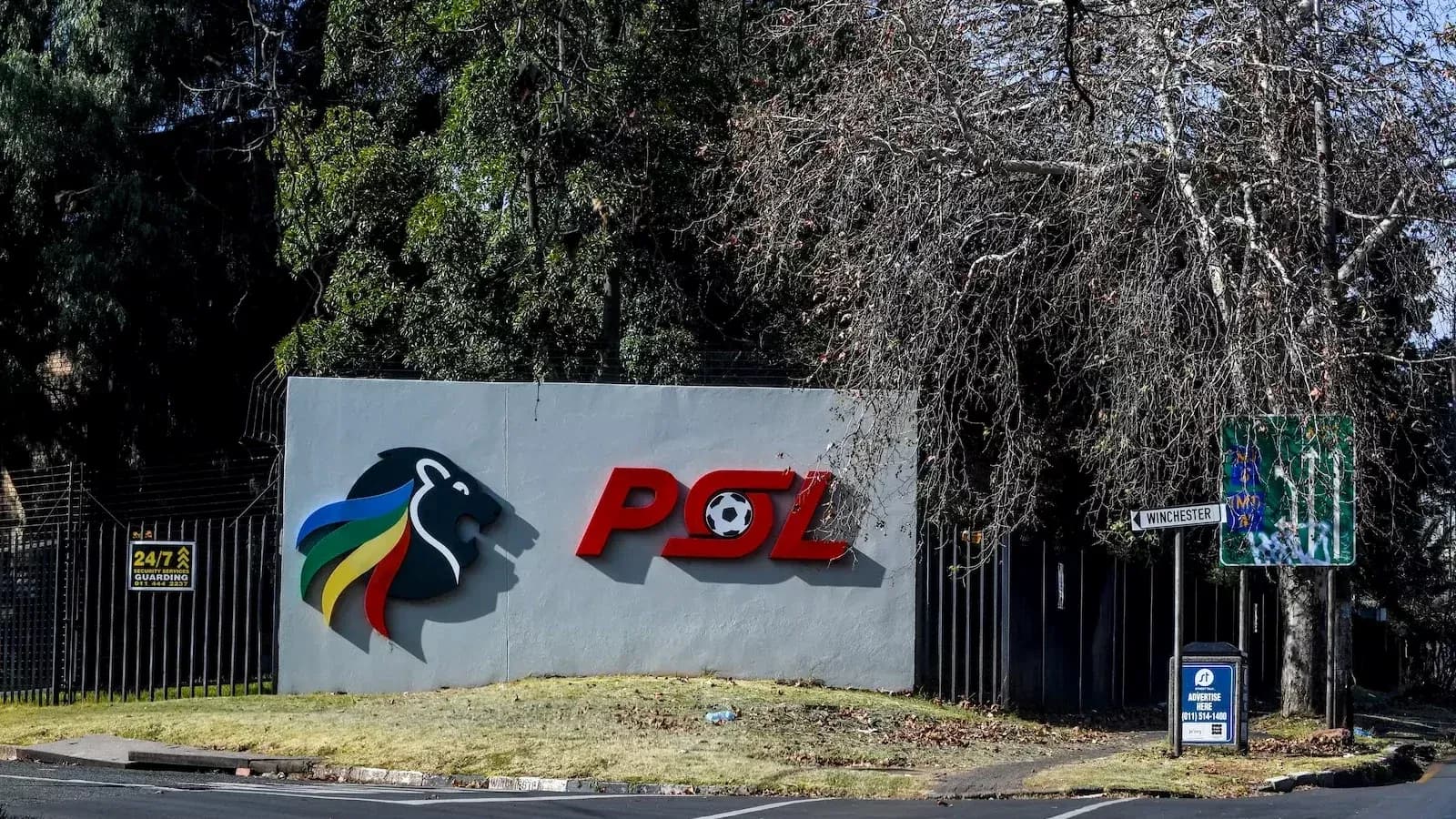 PSL logo on wall with street signs nearby PSL logo on wall with street signs nearby