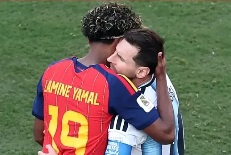 Lamine Yamal and Lionel Messi embracing on field Lamine Yamal and Lionel Messi embracing on field