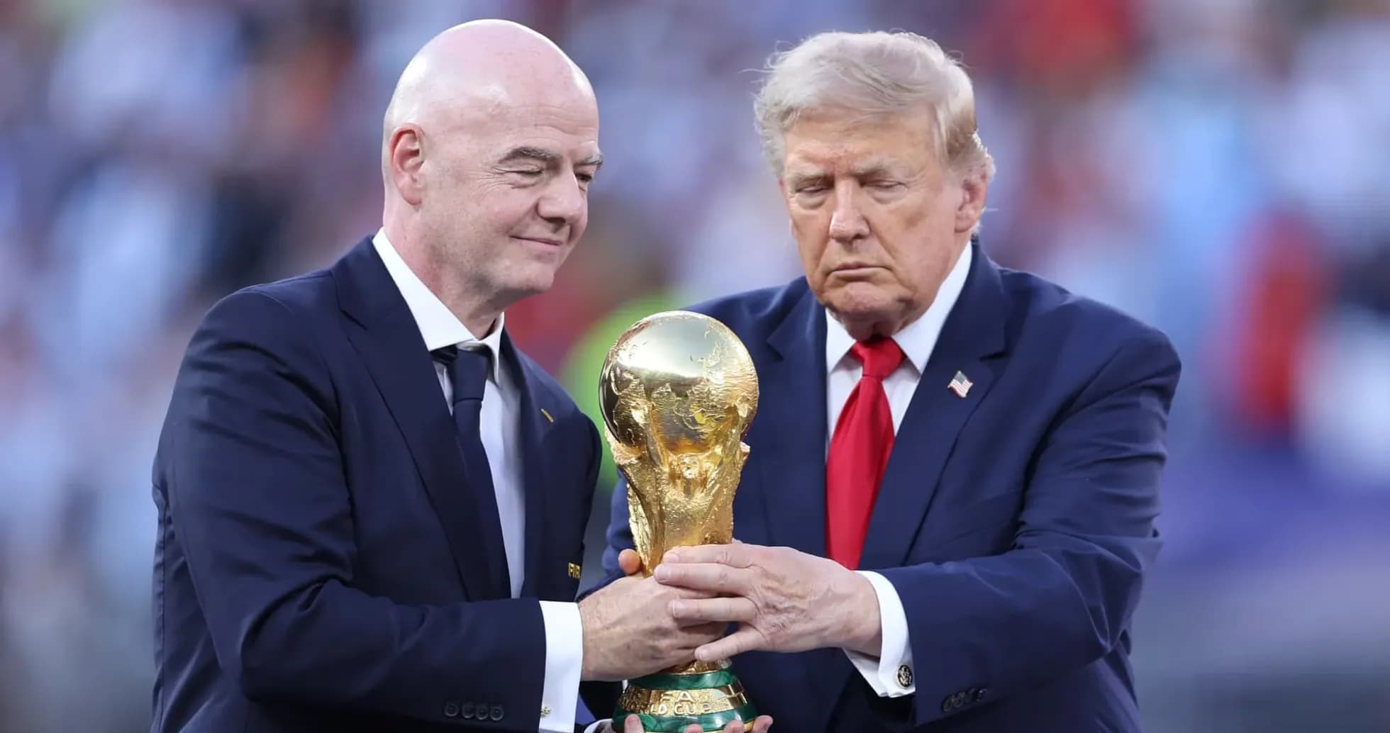 Gianni Infantino and Donald Trump holding World Cup trophy Gianni Infantino and Donald Trump holding World Cup trophy