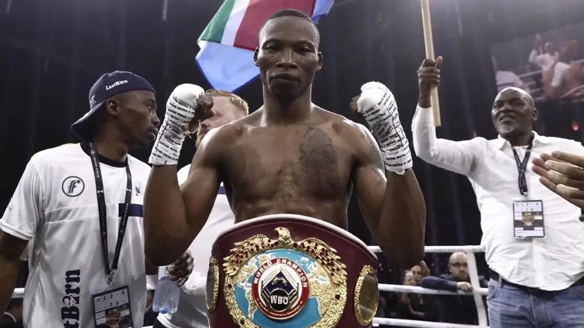 Boxer celebrating with championship belt in ring Boxer celebrating with championship belt in ring