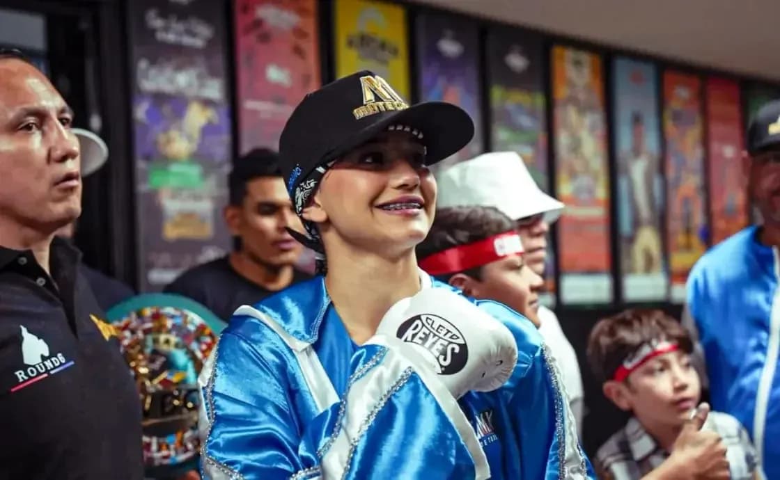 Young female boxer smiling with gloves before match Young female boxer smiling with gloves before match