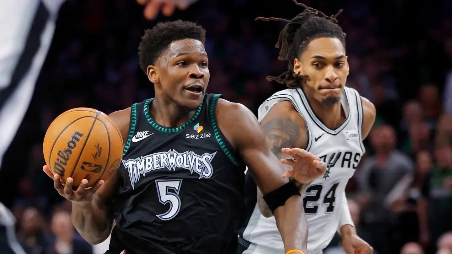 Player dribbling basketball with defender close behind Player dribbling basketball with defender close behind