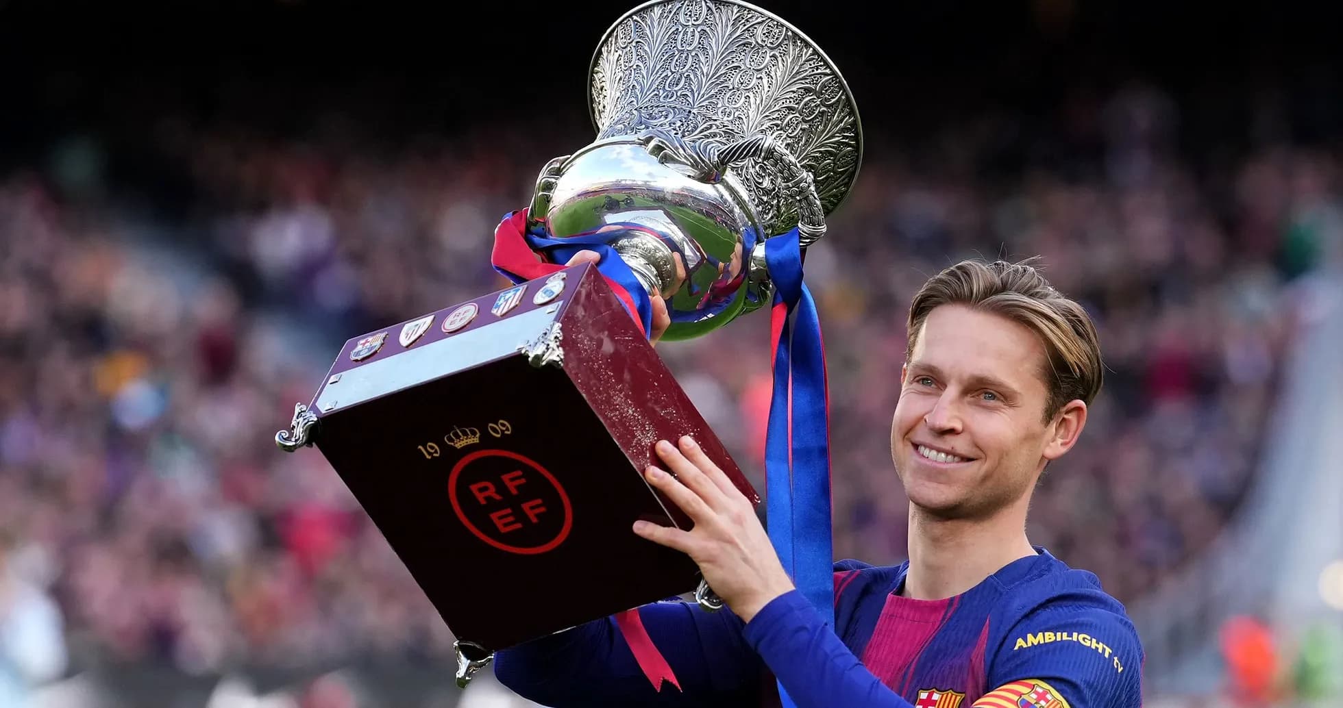Frenkie de Jong holding trophy after match victory Frenkie de Jong holding trophy after match victory