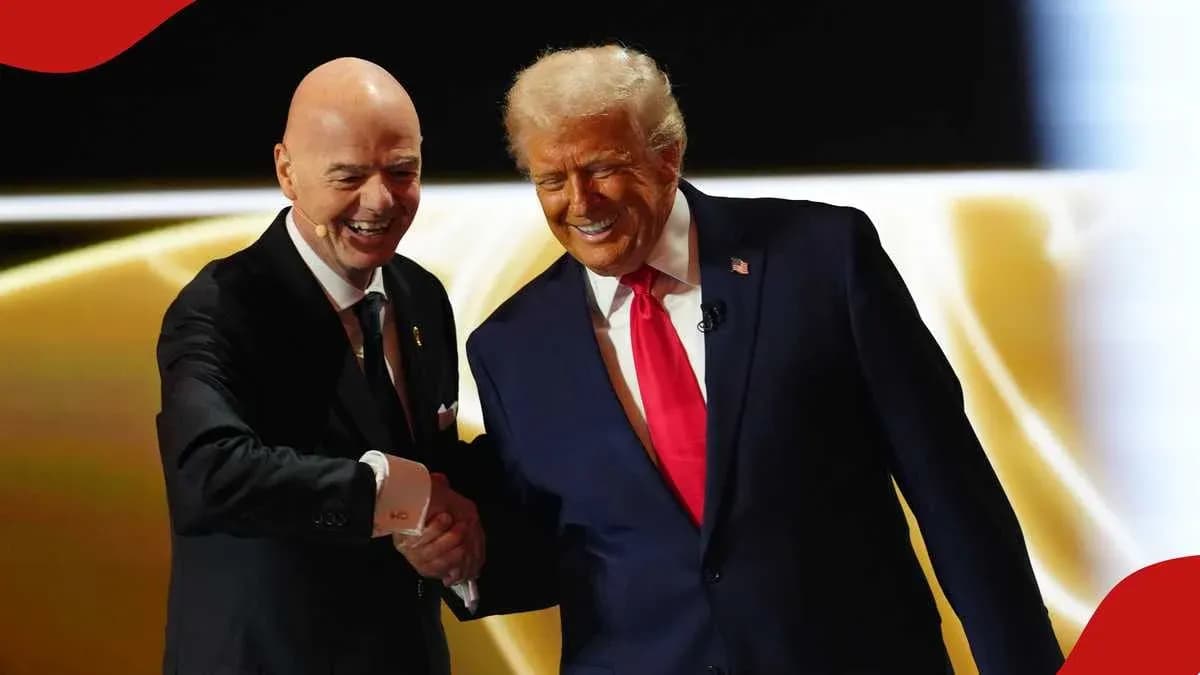 Two men shaking hands on stage during event Two men shaking hands on stage during event