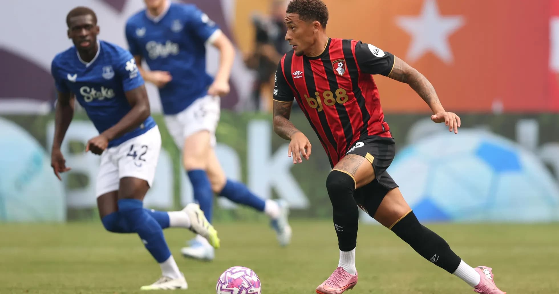 Bournemouth player dribbling past Everton defender Bournemouth player dribbling past Everton defender