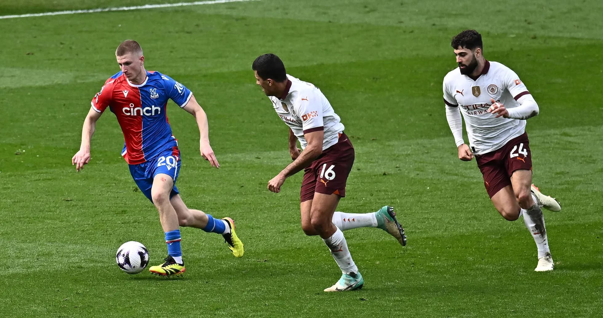 Crystal Palace player evading two defenders during match Crystal Palace player evading two defenders during match