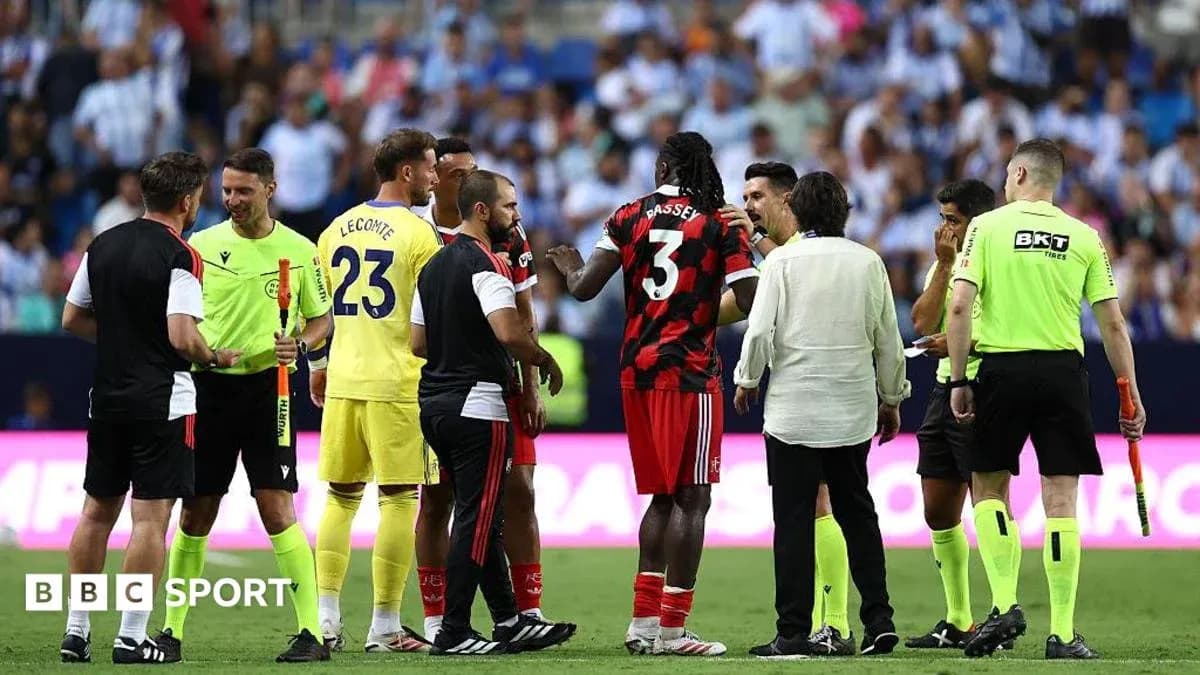 Players and referees discussing during match stoppage Players and referees discussing during match stoppage