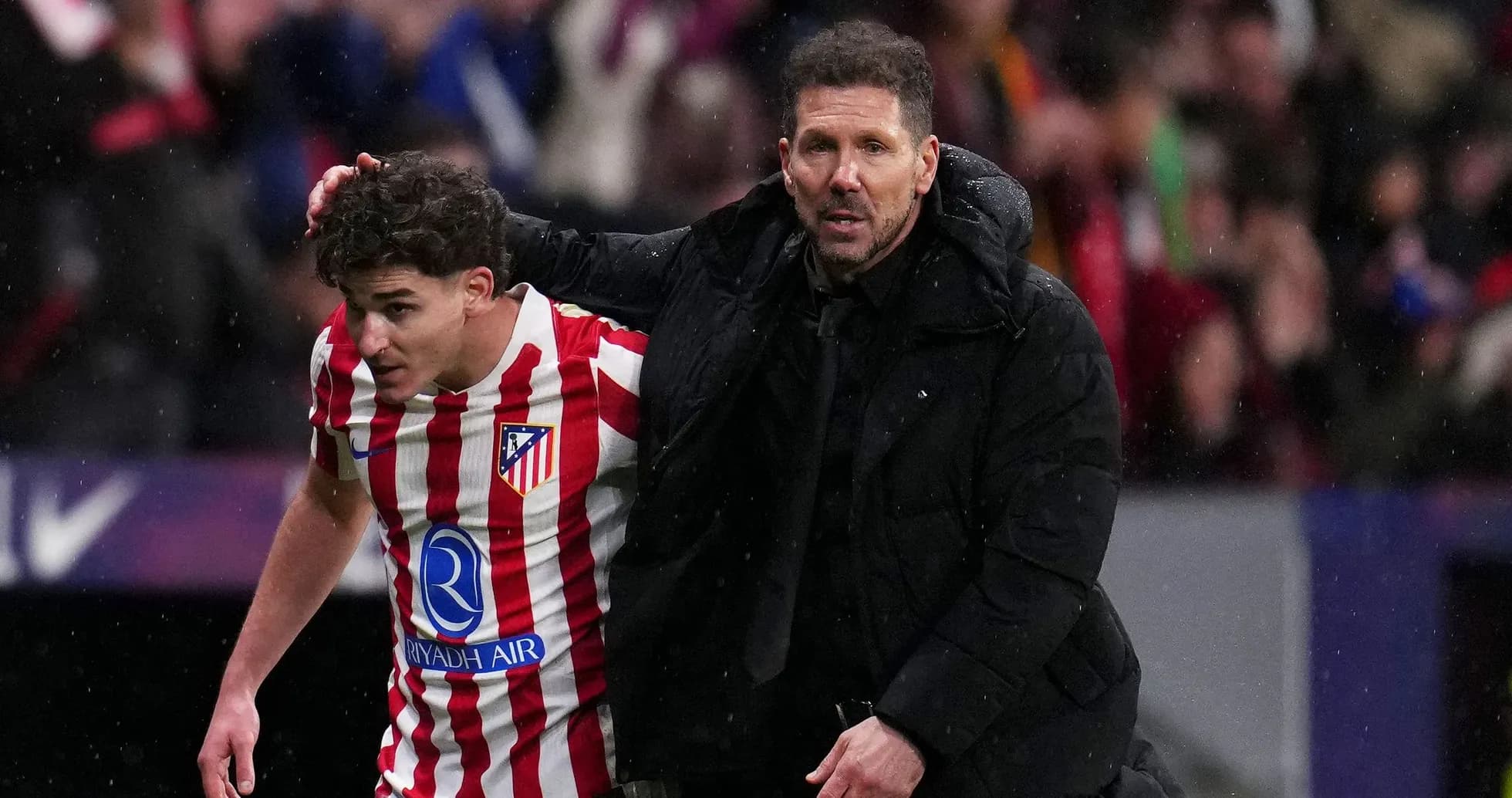 Atletico Madrid player and coach discussing on the field Atletico Madrid player and coach discussing on the field