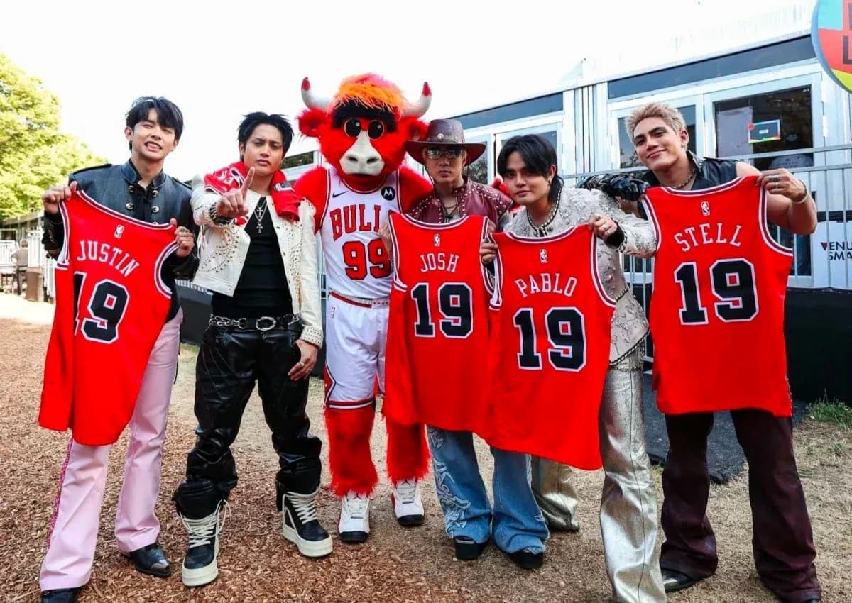 Group posing with basketball jerseys and mascot Group posing with basketball jerseys and mascot