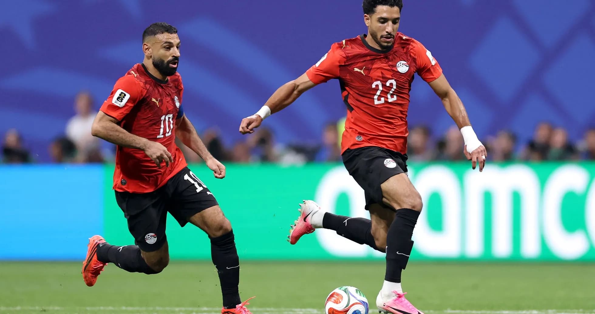 Egyptian players in red jerseys during match action Egyptian players in red jerseys during match action