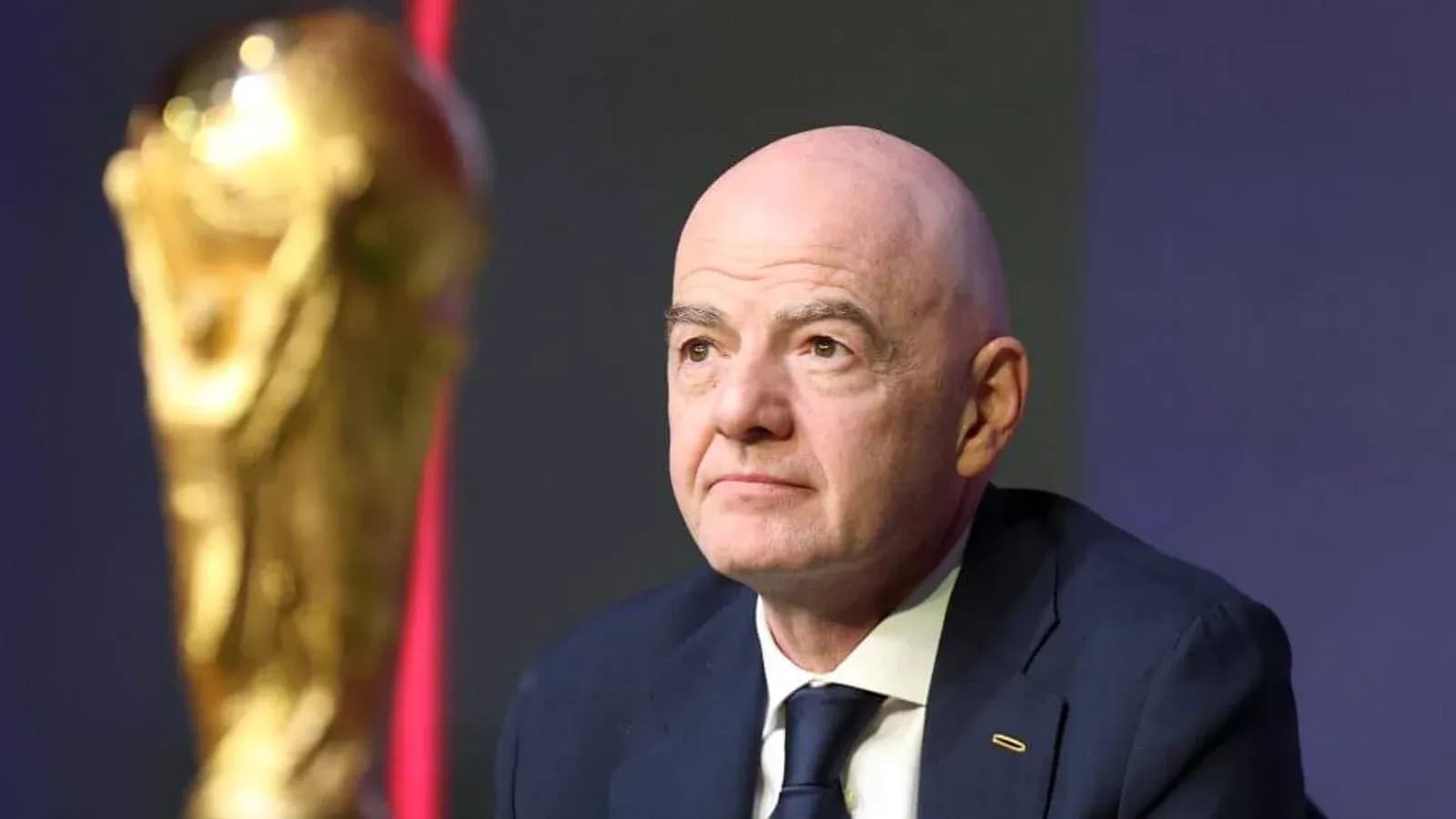 FIFA president with World Cup trophy at event FIFA president with World Cup trophy at event