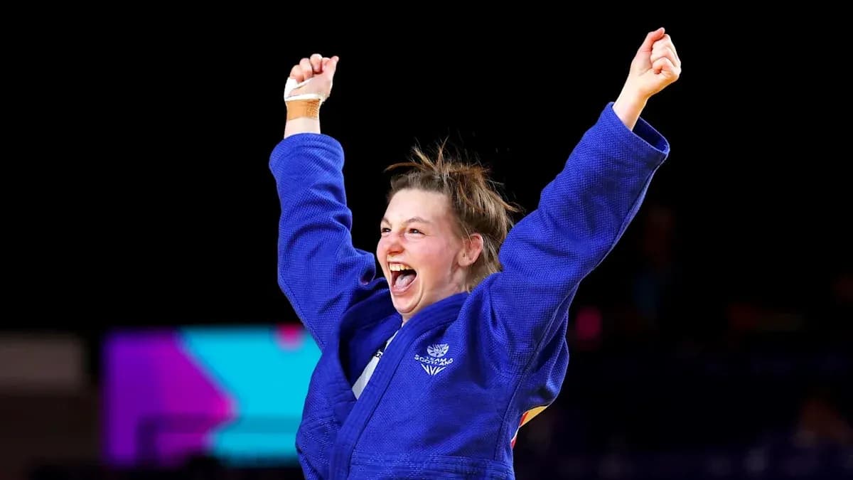 Judo athlete celebrating victory with raised arms Judo athlete celebrating victory with raised arms