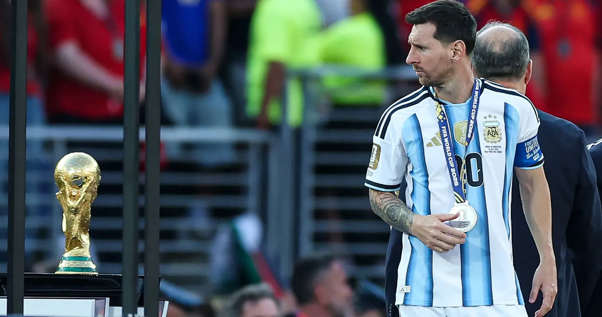 Lionel Messi walking past World Cup trophy after match Lionel Messi walking past World Cup trophy after match