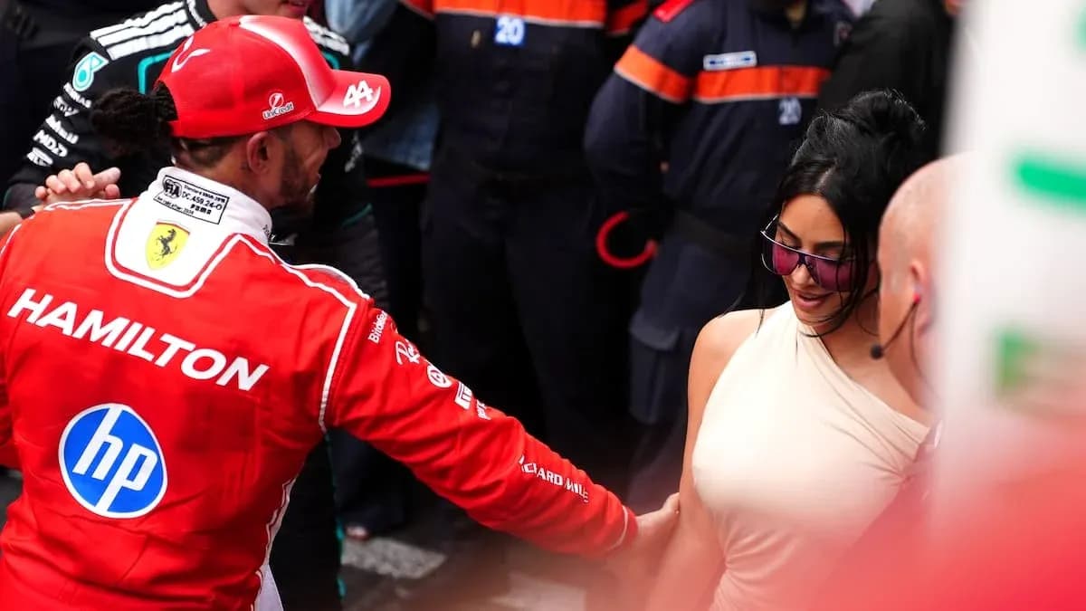 Formula 1 driver interacting with a woman in crowd Formula 1 driver interacting with a woman in crowd