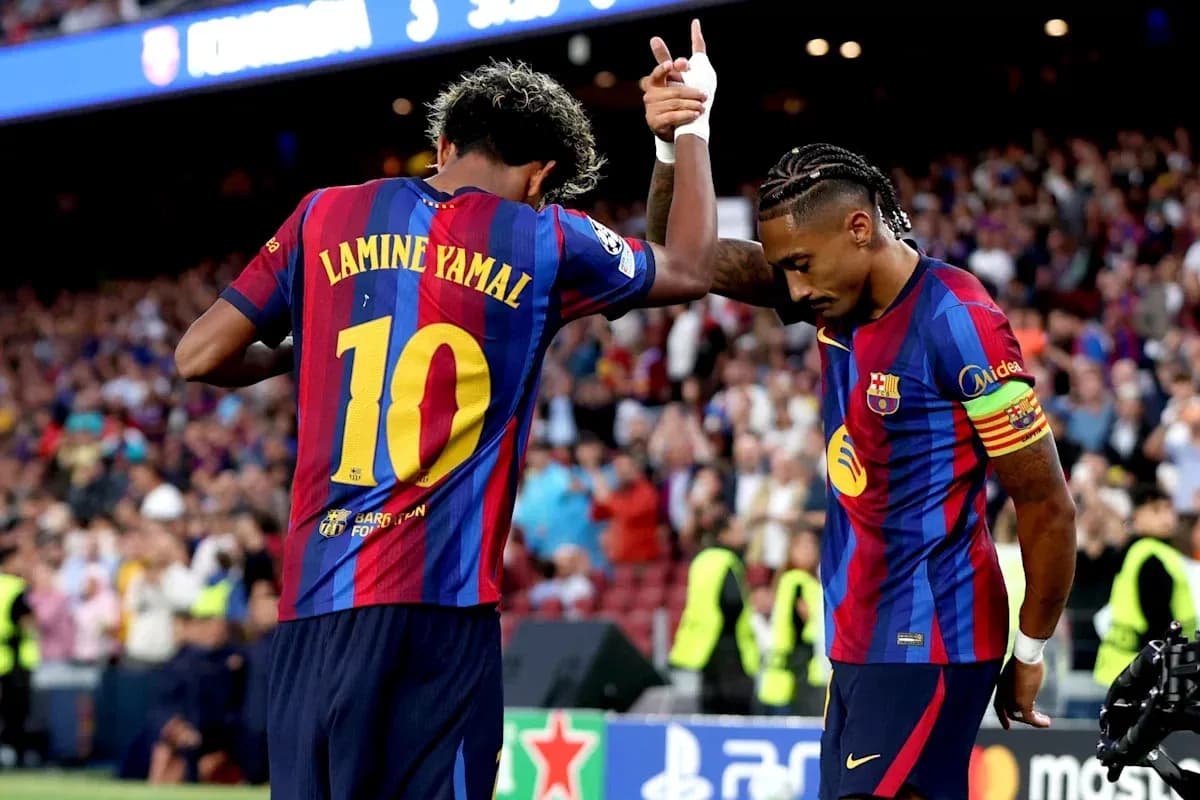 Two FC Barcelona players celebrating a goal Two FC Barcelona players celebrating a goal