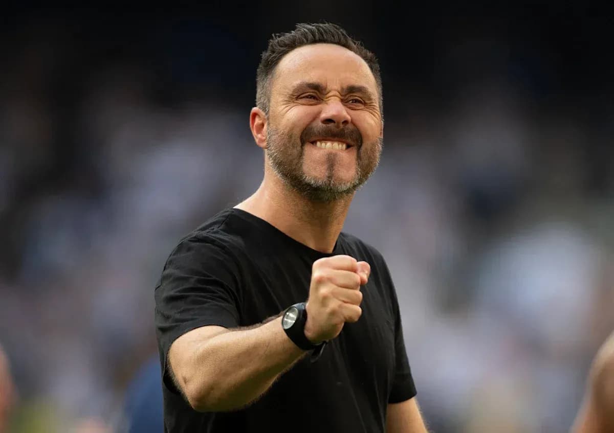 Coach celebrating with clenched fist on the field Coach celebrating with clenched fist on the field