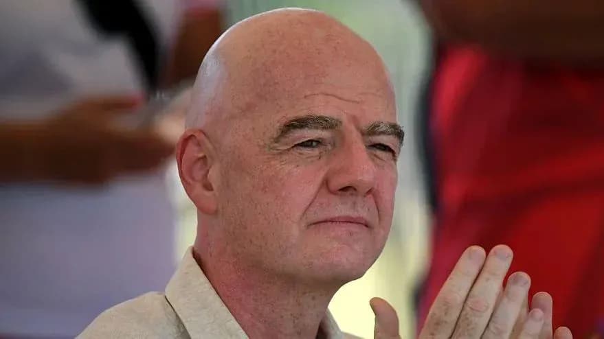 FIFA president attending an event, hands clasped FIFA president attending an event, hands clasped
