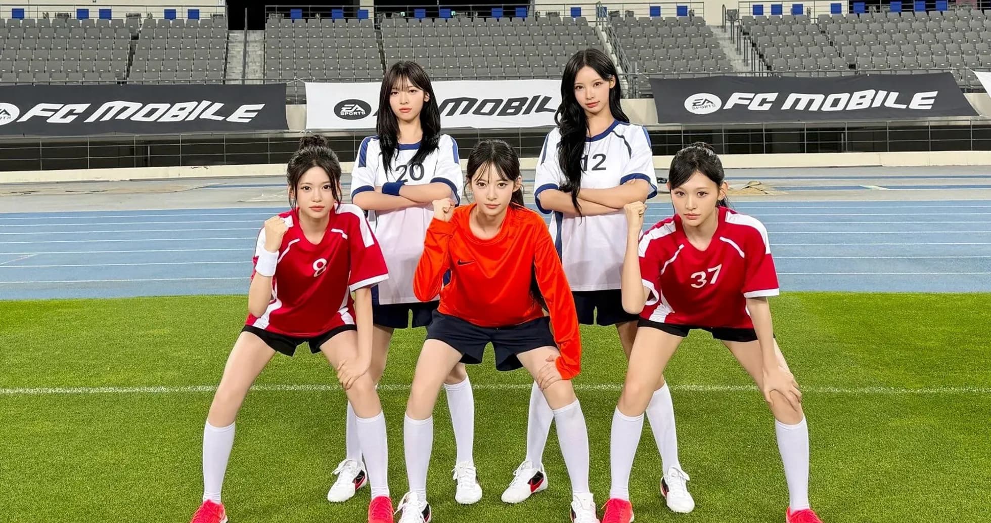 Five players posing in football kits on field Five players posing in football kits on field