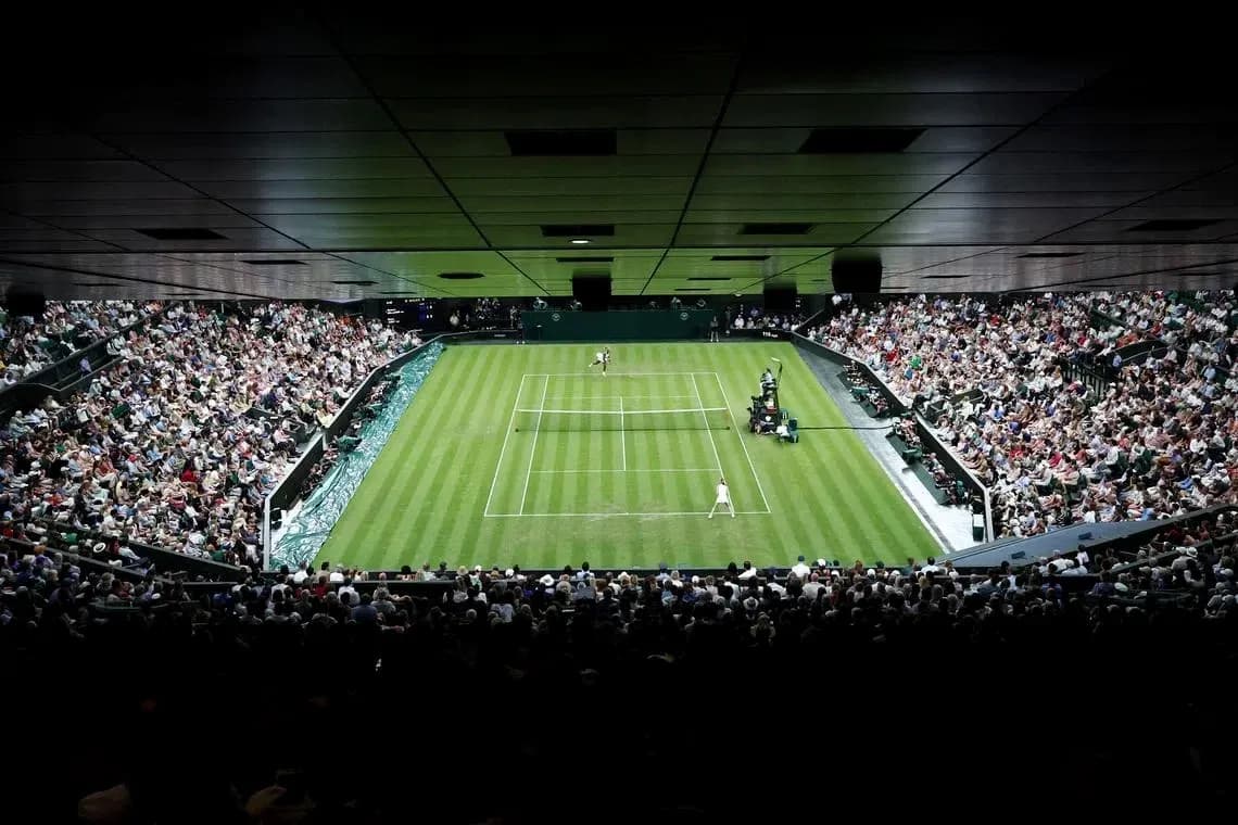Tennis match at Wimbledon with large crowd Tennis match at Wimbledon with large crowd