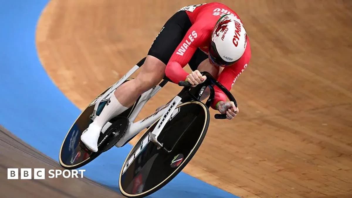 Velodrome cyclist representing Wales during a race Velodrome cyclist representing Wales during a race