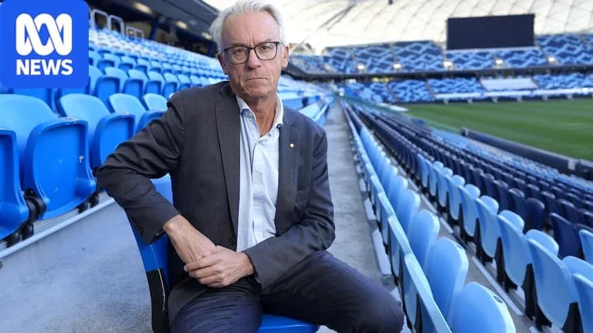 Man seated in empty stadium with blue seats Man seated in empty stadium with blue seats