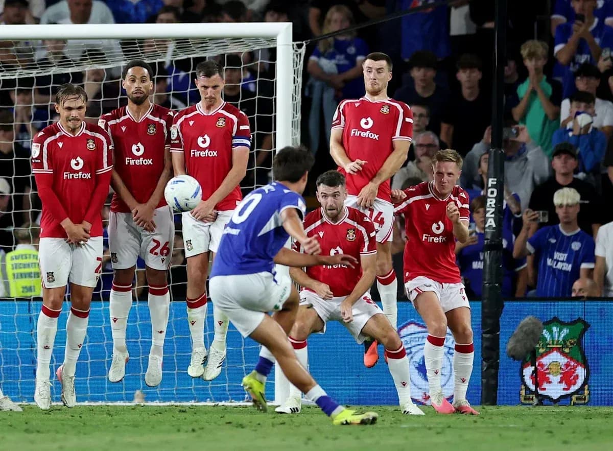 Player taking a free kick in front of wall Player taking a free kick in front of wall