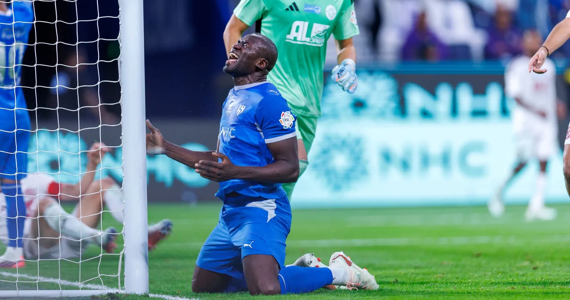 Player kneeling in front of goal post during match Player kneeling in front of goal post during match