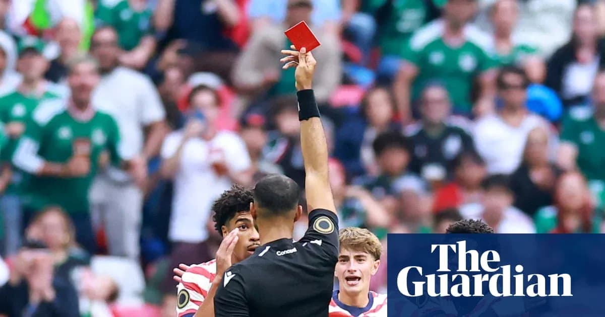 Referee showing red card to player during match Referee showing red card to player during match