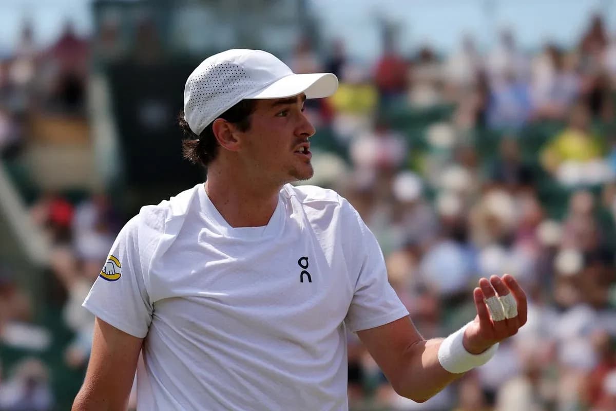 Tennis player gesturing during a match Tennis player gesturing during a match