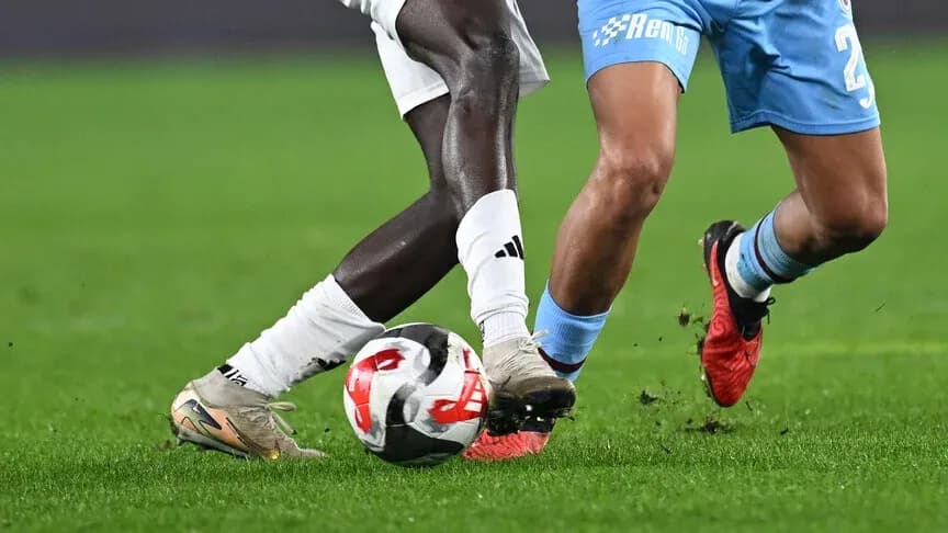 Two players competing for the ball on field Two players competing for the ball on field