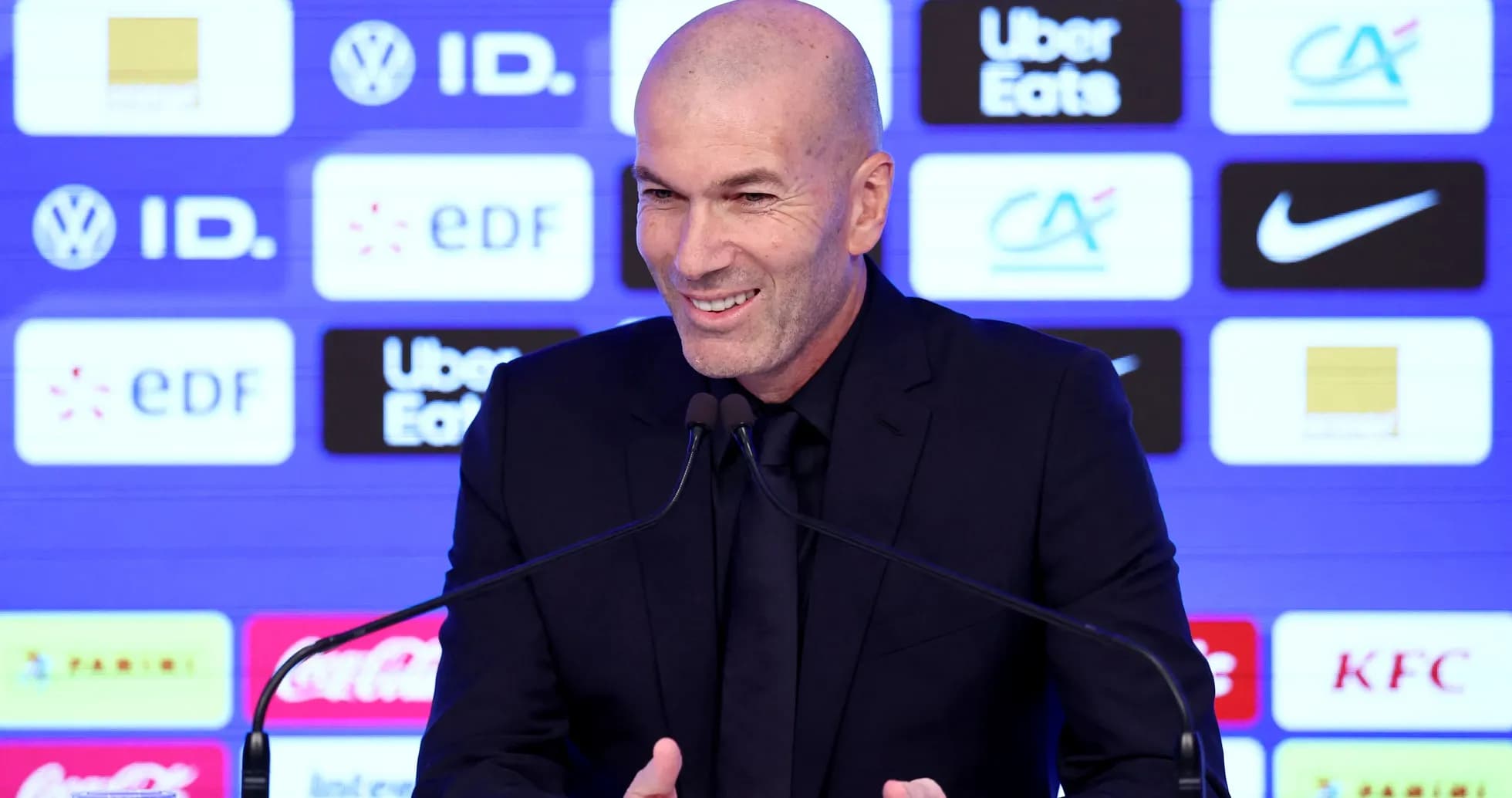Zinedine Zidane speaking at press conference podium Zinedine Zidane speaking at press conference podium