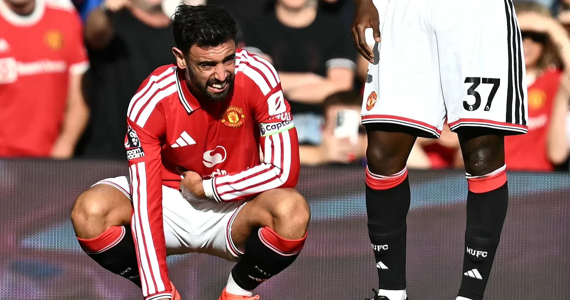 Bruno Fernandes crouching on pitch during match Bruno Fernandes crouching on pitch during match