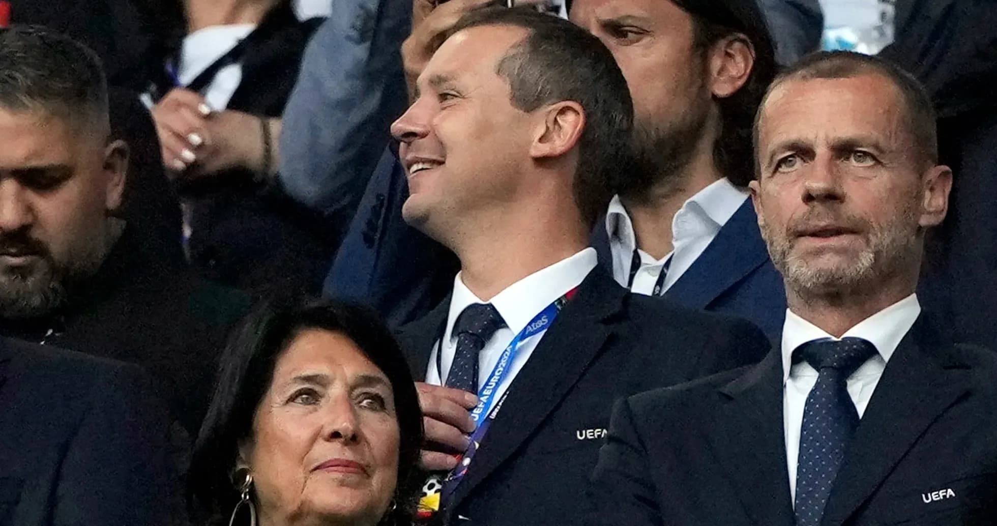 Officials watching a football match in the stands Officials watching a football match in the stands