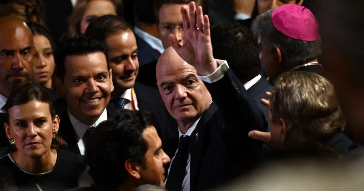 Man waving amidst a crowd at an event Man waving amidst a crowd at an event