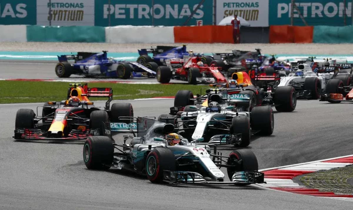 Formula 1 cars racing at the track Formula 1 cars racing at the track